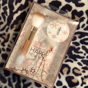 Rose gold eyelash curler, brush, and mirror